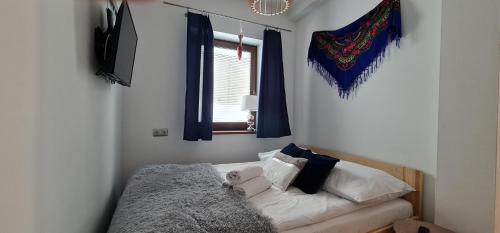 a bedroom with a bed with a teddy bear on it at Apartament na brzyzku in Zakopane