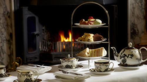 a table topped with plates and cups of tea at Brockencote Hall in Kidderminster