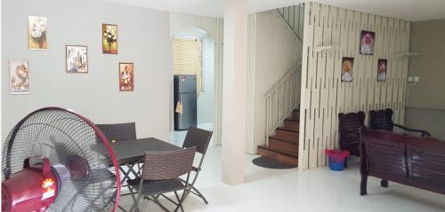 a dining room with a table and a fan at J & I Homestay 2 Person with shared bathroom in Sibu