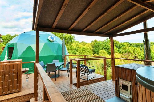 a deck with a tent and a table and chairs at Finest Retreats - Scotney Luxury Dome in Hoath