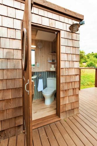 a bathroom with a toilet inside of a building at Finest Retreats - Scotney Luxury Dome in Hoath