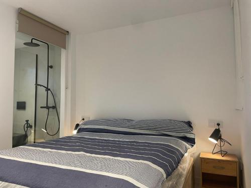a bedroom with a bed and a glass shower at WASELA 114 in Palamós