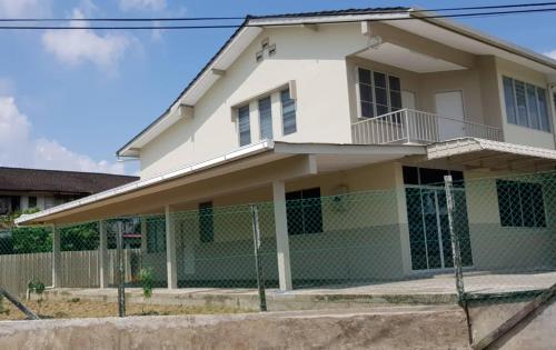 a white house with a fence in front of it at J & I Homestay B 3 Person with shared bathroom in Sibu