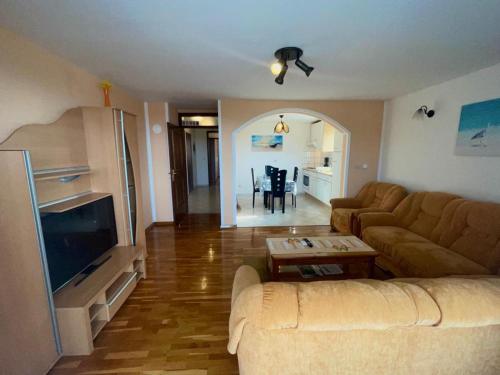 a living room with a couch and a table at Apartmani Krajnović in Fažana