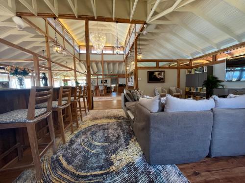 a living room with couches and a bar at Aloha 5 in Ponta Mamoli