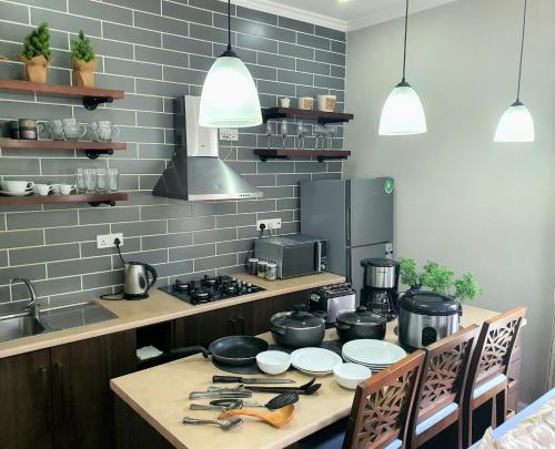 a kitchen with a table with pots and pans at Luxe Wilderness in Nuwara Eliya