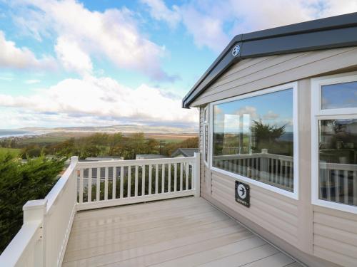 a large deck with a view of the mountains at Gwent 74 in Borth