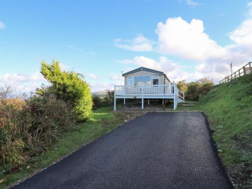 a small house on the side of a road at Gwent 74 in Borth