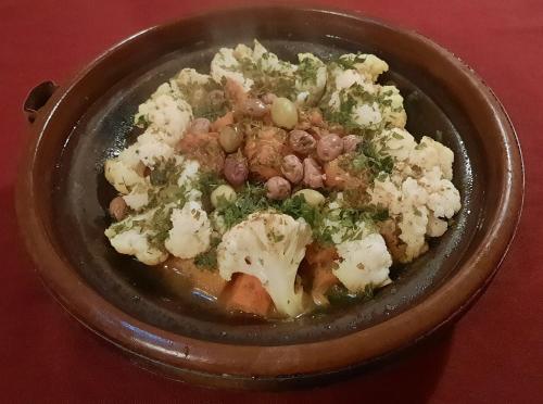 a bowl of food with meat and vegetables on a table at Maison d'Hôtes Irocha in Tisselday