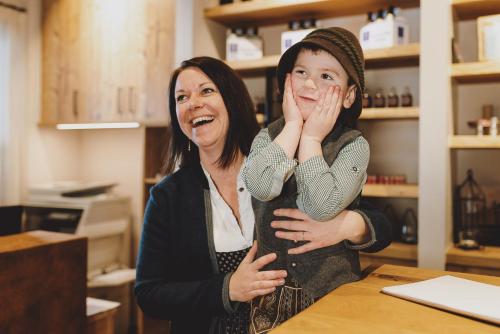 a woman and a child standing at a table at Appartements Liebe Heimat in Saalbach Hinterglemm