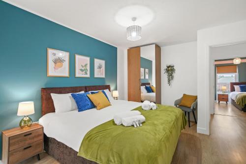 a bedroom with a large bed with towels on it at East London Townhouse sleeps 7 with 1 parking space in Goodmayes