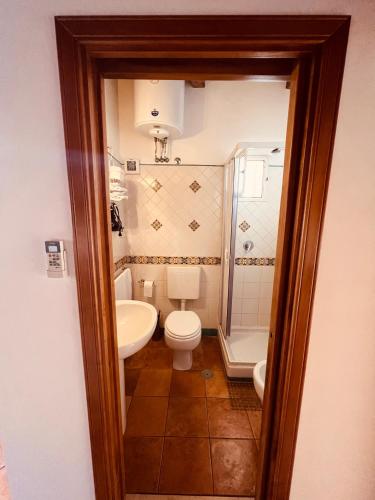 a bathroom with a white toilet and a sink at JP House Amalfi in Amalfi