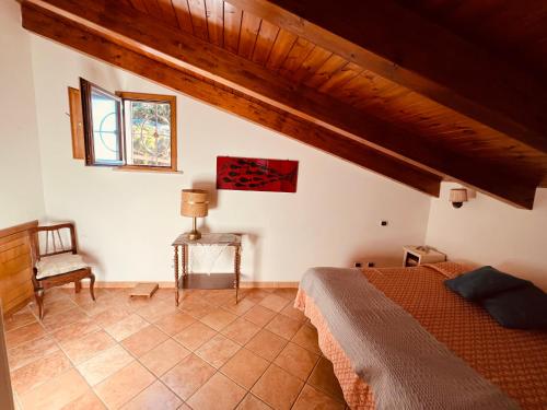 a bedroom with a bed and a chair in a room at JP's House in Amalfi