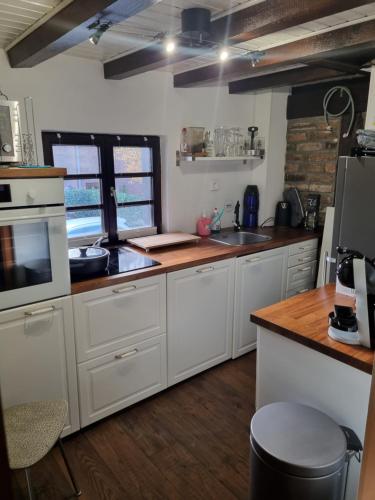 a kitchen with white cabinets and a counter top at altes romantisches Fachwerkhaus in Rheinnähe auch für Workation geeignet in Cologne
