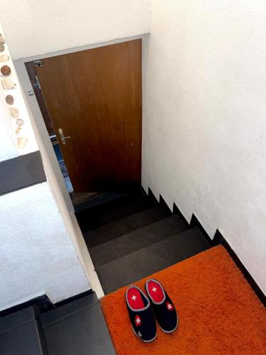 two pairs of shoes on the floor in front of a door at Old Farmhouse Loft near Vaduz in Sevelen