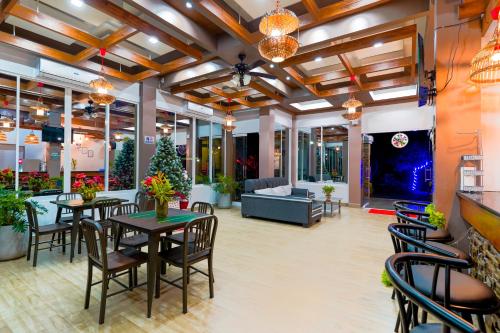 a lobby with tables and chairs and a couch at MS Mountain Cabin in Loboc