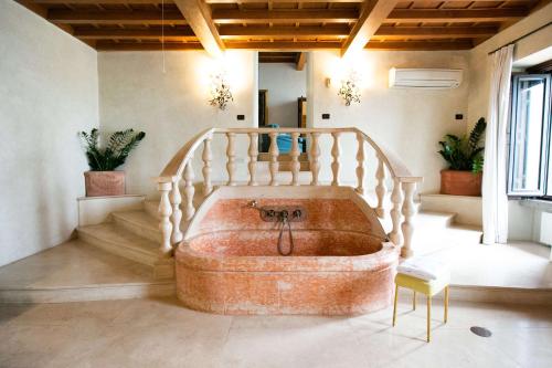 a bath tub in a room with a staircase at La Posta Vecchia Hotel in Ladispoli