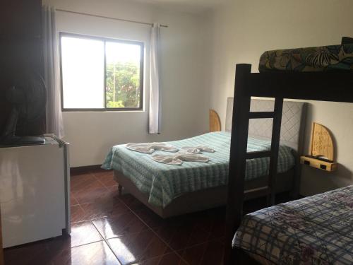 a bedroom with two bunk beds and a window at Pousada La Marea in Rio Grande