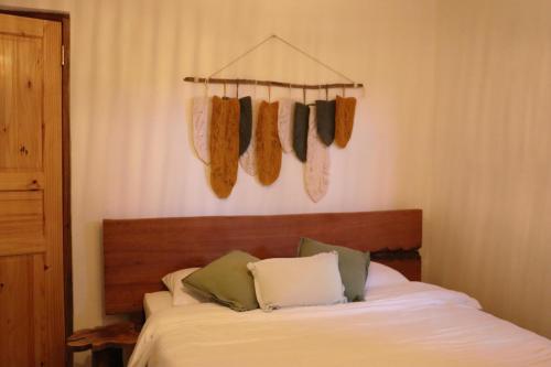 a bedroom with a bed with socks hanging on the wall at Casa Wabi Sabi in Pedasí Town