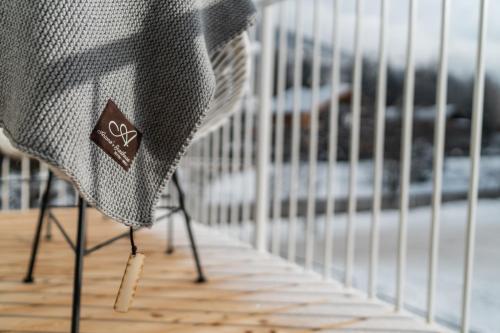 a chair with a sticker on it next to a fence at Ariane's Guesthouse in Sesto