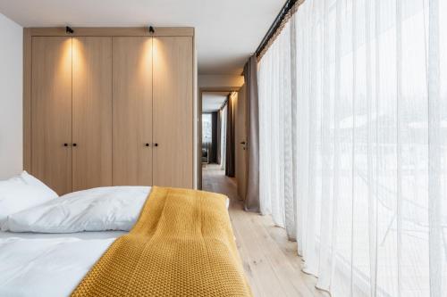 a bedroom with a bed and a large window at Ariane's Guesthouse in Sesto
