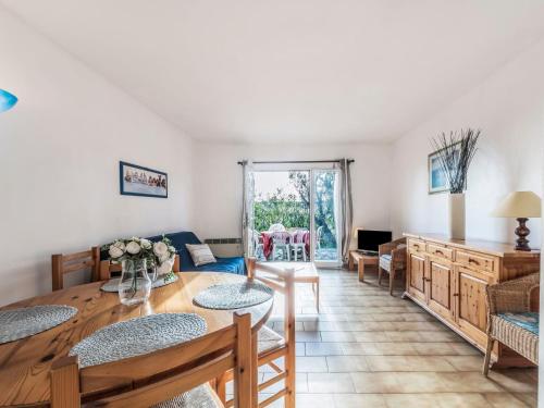 a living room with a table and chairs at Holiday Home Bonporteau-3 by Interhome in Cavalaire-sur-Mer