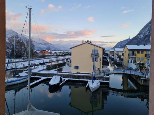 a marina with boats in the water and buildings at Apartment Apt C4-R - Résidence Bougainville by Interhome in Bouveret