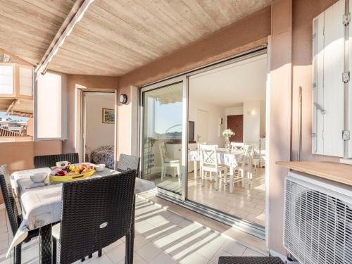 a kitchen and dining room with sliding glass doors at Apartment Les Jardins del Mar-2 by Interhome in Cavalaire-sur-Mer