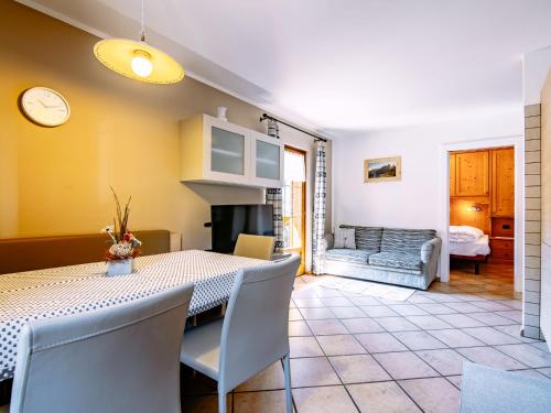 ein Esszimmer mit einem Tisch und einem Sofa in der Unterkunft Apartment Carmen-4 by Interhome in Soraga