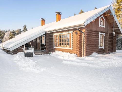 a log cabin in the snow with snow around it at Holiday Home Ruka-kitkan lomamajat-varpunen by Interhome in Säkkilänvaara