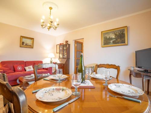 a dining room with a table and a couch at Apartment Cardella by Interhome in Saint Malo