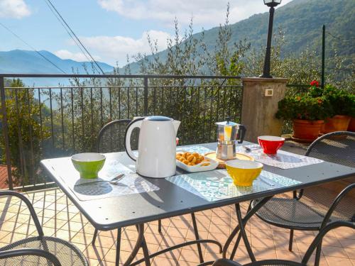 a table with a tea kettle and bowls of food at Apartment Casa 51 by Interhome in Erli