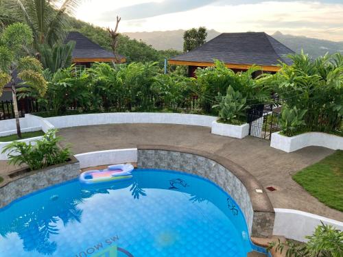 a swimming pool in a yard with a house at MS Mountain Cabin in Loboc