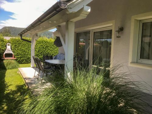 a patio with a table and chairs under a pergola at Holiday Home Seehaus Blue Faak by Interhome in Faak am See