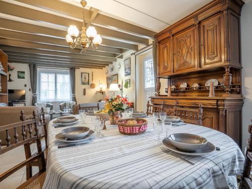 a dining room with a table with dishes on it at Holiday Home Saint Ideuc by Interhome in Saint Malo