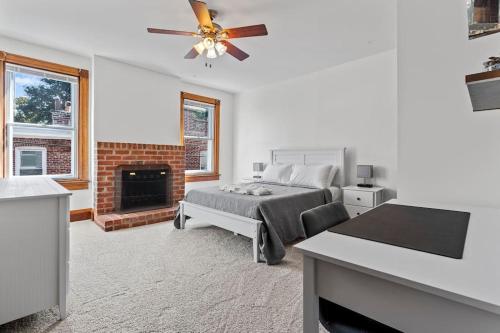 a bedroom with a bed and a fireplace at Spacious Home in Heart of Historic Fan District in Richmond