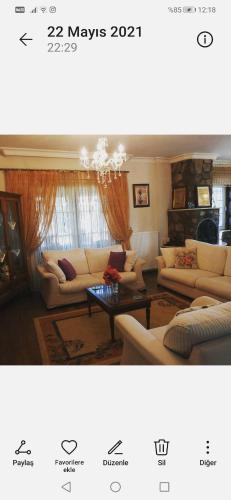 a living room with couches and a table at Villa Latanya in Dalaman