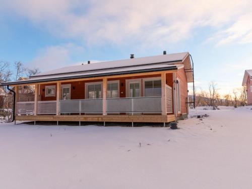a tiny house in the snow in a field at Holiday Home Saana 4 by Interhome in Kilpisjärvi