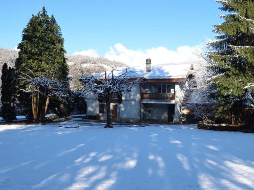 a house with snow on the ground in front of it at Apartment Le Verger by Interhome in Bex