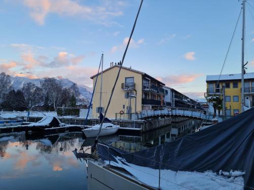 a boat docked in a marina next to a building at Apartment Tasman S16-R by Interhome in Bouveret