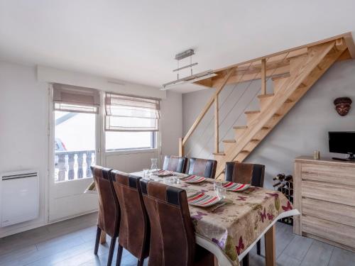 a dining room with a table with chairs and a staircase at Apartment L'Orée du Parc by Interhome in Saint-Gervais-les-Bains