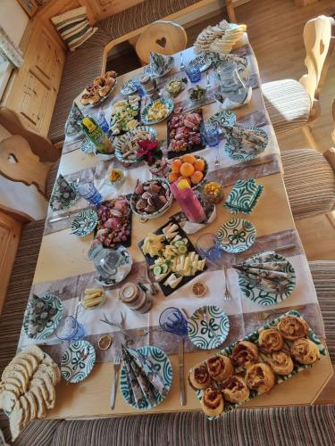 a table with a bunch of food on it at Urlaub am Bauernhof bei Familie Steinbrecher in Bad Mitterndorf