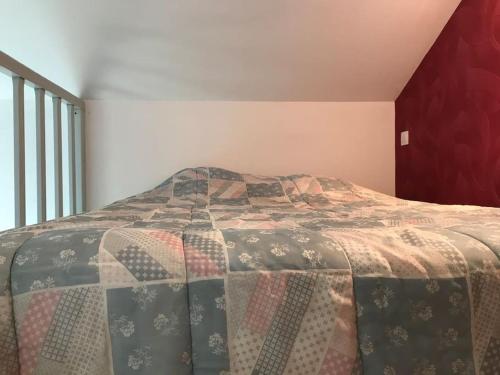 łóżko z kołdrą w sypialni w obiekcie Chalet bois proche de la Dordogne, Eymet a 5 km w mieście Soumensac