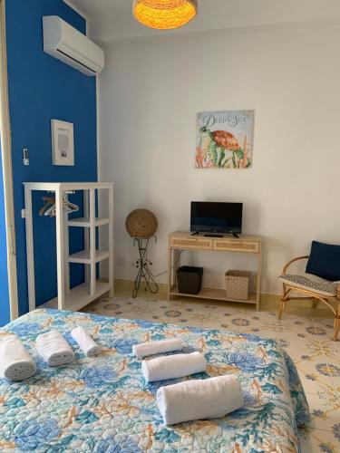 a bedroom with a large bed with three pillows on it at Mille tramonti Agropoli sunset suite in Agropoli