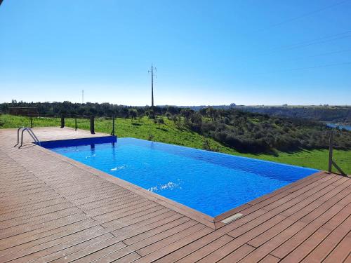 a large swimming pool on a wooden deck at Naturarte Rio - Duna Parque Resorts & Hotels in Vila Nova de Milfontes