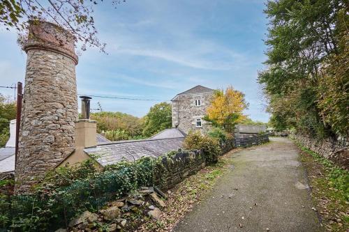 an old brick chimney on the side of a house at Your luxurious and secluded retreat in Cornwall in Helston
