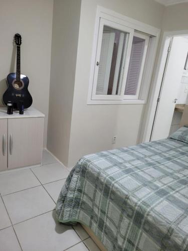 Katil atau katil-katil dalam bilik di Excelente Casa Duplex em Tramandaí