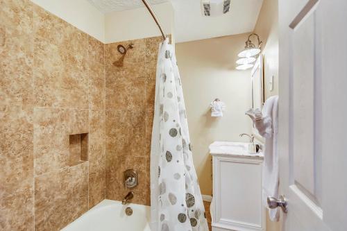 a bathroom with a shower with a shower curtain at Barefoot Bungalow in Galveston