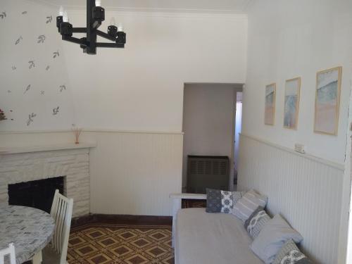 a living room with a bed and a fireplace at La Casa de Ischia in Mar del Plata