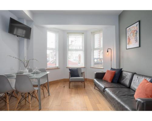 a living room with a couch and a table at Central Belfast Apartments Eden in Belfast